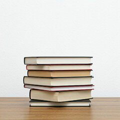 stack of books on the table. pile of books. stack of books. close up of stack of books in a room.