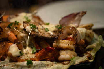 A picture of mixed seafood sizzler with prawns,fish,lobster,squid,vegetables and rice