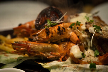 A picture of mixed seafood sizzler with prawns,fish,lobster,squid,vegetables and rice