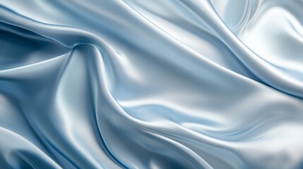 Fototapeta premium An elegant soft blue silk fabric draped gracefully with a shimmering, satin-like texture. The light color and glossy finish provide a refined and minimalist background with ample space for text 