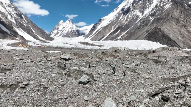 Hikers moving along the Gondogoro La trail with views over K2, Pakistan