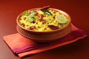 Lemon rice is cooked at home or served in temples a popular dish in South India