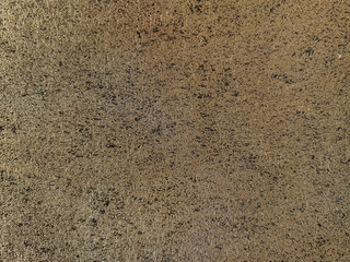 Gold textured paint or golden textured paint washed on a wall or panel, seamless texture, random texture. No people.
