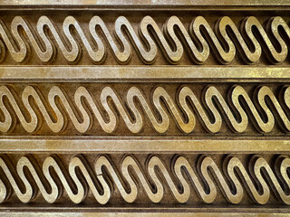 Texture of ethnic curves engraving crafted on solid wood panel. Solid teak wood art with curves and...