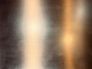 Gold metallic stainless steel sheet in hairline brushed pattern with shades of lights and reflection effects. Stainless steel contour and effects, gold copper and brass color.