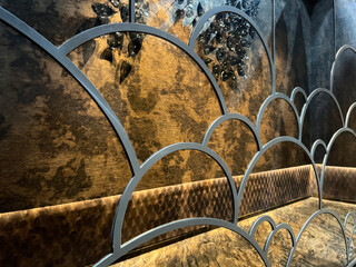 Bronze mirror reflection and curves cloud shape art on bronze mirror, seen here the reflection of the decoration and accessories in front of bronze mirror. Interior design luxurious concept.