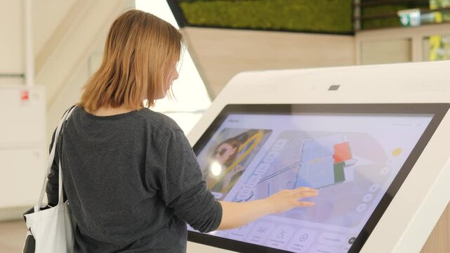 Girl studying a map plan in a modern shopping center mall.