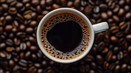 Fototapeta premium Celebrate International Coffee Day with a captivating top view of a perfectly brewed coffee cup surrounded by coffee beans, highlighting the rich textures and aromas of your favorite brew