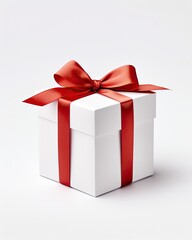Fototapeta premium White gift box tied with red ribbon bow isolated on studio background