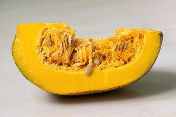 Fresh pumpkin cut into pieces. Inside view of half sliced pumpkin.