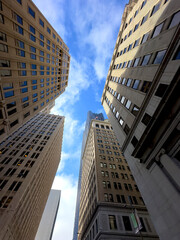 Fototapeta premium Worm's-Eye View of San Francisco Financial District: Modern and Historical Architecture Under Clear Skies with Light Clouds Drifting. 