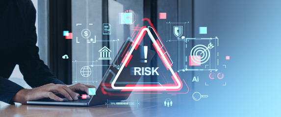 Businessperson Typing on Laptop with Risk Management Icons and Digital Overlay.
