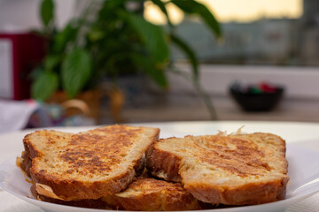 Three slices of toast are on a white plate
