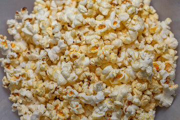 A bowl of popcorn is shown in a close up