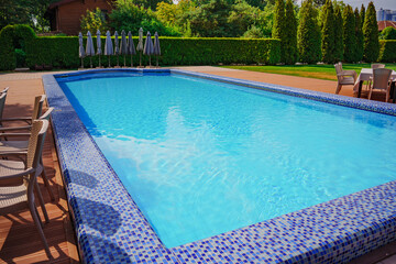 large swimming pool. ripples on the blue water in the pool. water purification in swimming pools. Relaxing in the water.