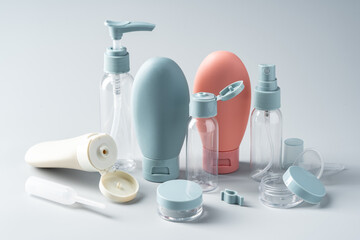 Variety of travel-sized containers displayed against a bright blue background