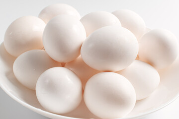 White eggs on a white plate.