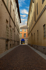 Urban landscape of Parma featuring a narrow alley in historic center