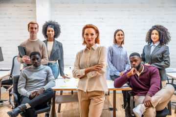 Portrait of a female manager standing next to coworking colleagues