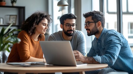 Obraz premium Three Diverse Individuals Working Together on a Laptop