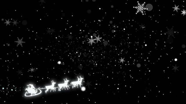 Felicitaci&oacute;n de navidad en ingles con letras de oro y nevada con copos de nieve