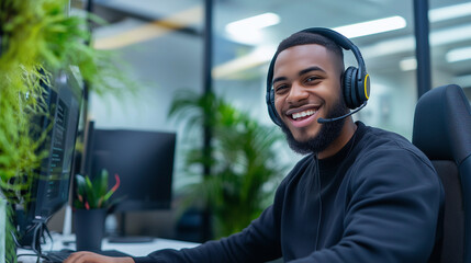 A smiling customer support agent, wearing a premium headset, sits in a brightly lit, spacious office, assisting a client. His relaxed yet professional demeanor is complemented by t