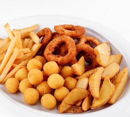 Enjoying plate of deep fried onion rings, french fries, potato wedges, and cheese balls