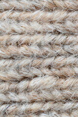 The texture of fabric thick beige sweater close-up. Knitted texture background
