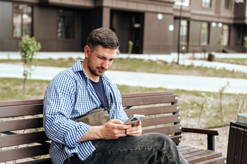 Young man sitting on a bench in a park