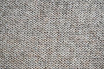  texture of knitted light brown sweater, close-up texture of beige knitted fabric, macro texture of tan knitted woolen clothes