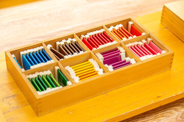 Montessori color tablets neatly stored in a wooden box