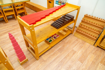 Montessori shelf with pink tower and educational blocks