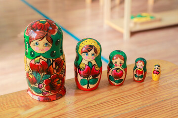 Traditional wooden Russian nesting dolls in various sizes on table