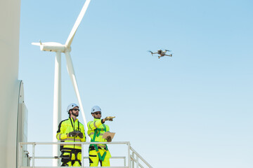 Team of electrical engineer is perform the inspection and maintenance of electric generating windmill turbine.