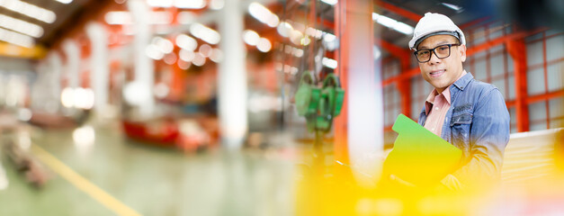 Senior industrial or machinery engineer is performing inspection a machines.