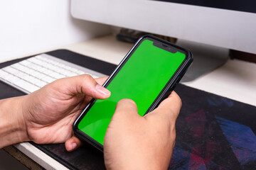 Phone mobile telephone with a vertical green screen in tram chroma key smartphone technology cell phone on white background isolate