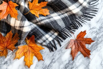 Autumn coziness with plaid blanket maple leaves on marble