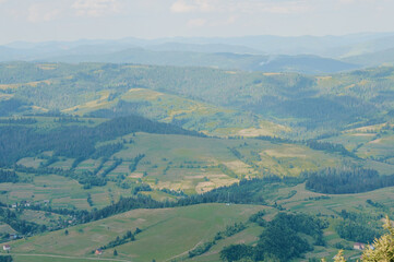 Serene Hills of Green: A Tranquil Landscape of Rolling Meadows and Distant Mountains
