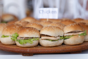 Tasty Chicken Lettuce Buns: Sesame Seed Bread and the Hungry Games Concept. Blurry background.