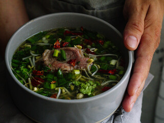 Thai pho bo soup with meat and vegetables
