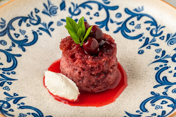 Cherry bread kadayif (ekmek kadayifi) with buffalo clotted cream on wooden table