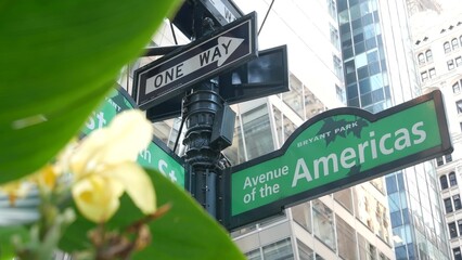New York City crossroad, street intersection green road sign. 6 Sixth ave, Americas avenue corner, Midtown business district, NYC, Bryant park. Highrise skyscraper architecture, one way text roadsign.