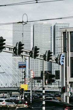 A vibrant cityscape showcasing modern skyscrapers and the iconic Erasmus Bridge on a cloudy day, emphasizing urban life and architectural design harmony  in Rotterdam
