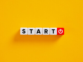 Start concept shown by letter cubes with power button icon on yellow background