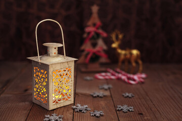 Christmas or New Year background with yellow lamp light, christmas tree and reindeer