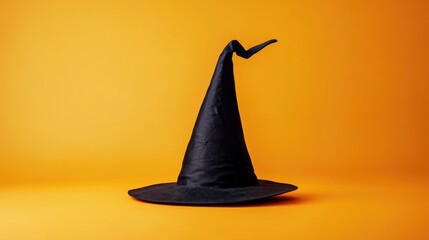 Fototapeta premium Witch hat or wizard hat isolated on orange background