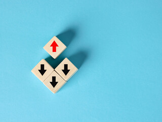 Red arrow pointing up on top of wooden blocks with black arrows pointing down