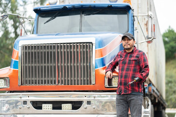 Portrait of truck driver with prosthetic arm outside truck