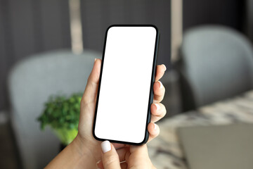 female hand holding phone with isolated screen background table office