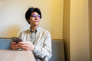 Man using mobile phone indoors